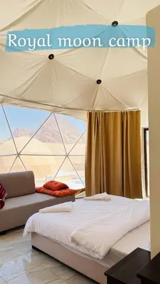 a bedroom with a bed and a couch in a tent at ROYAL MOON BUBBLES lUXURY CAMP in Wadi Rum