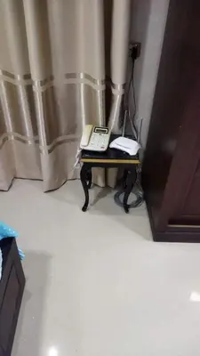a telephone sitting on a table in a room at Rest Inn in Kerak
