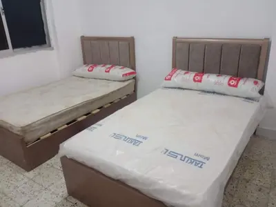 two twin beds in a room withthritisthritisthritisthritisthritisthritisthritisthritisthritis at Rest Inn in Kerak