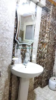 a bathroom with a sink and a mirror at Rest Inn in Kerak