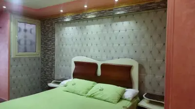 a bedroom with a bed and a brick wall at Rest Inn in Kerak