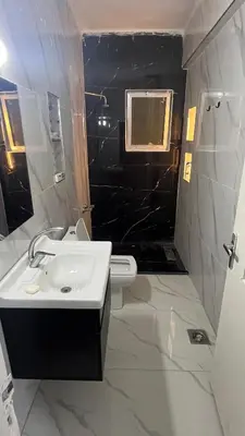 a bathroom with a sink and a toilet at Bait Al-Masri in Um Qeis