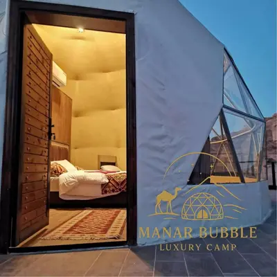 a room with a tent with a bed in it at Manar Bubbel Luxury Camp in Wadi Rum