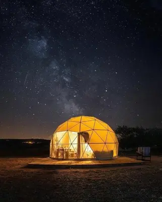 a large dome tent under a starry sky at night at MOON RUM lUXURY CAMP in Wadi Rum