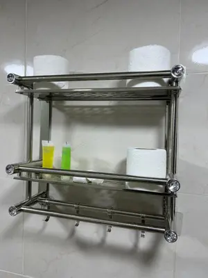 a metal towel rack with toilet paper and two cups at MOON RUM lUXURY CAMP in Wadi Rum
