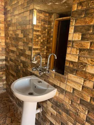 a bathroom with a sink and a mirror at Um sabatah camp in Wadi Rum