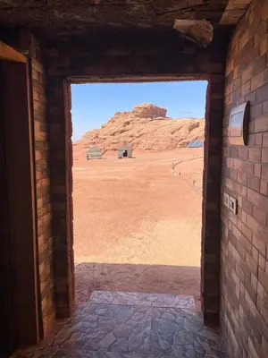 an open door to a room with a view of the desert at Um sabatah camp in Wadi Rum