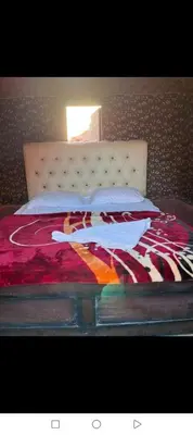 a bed with a blanket on top of it at Um sabatah camp in Wadi Rum