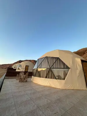 two large tents on a patio in the desert at Wadi Rum Neom camp in Wadi Rum