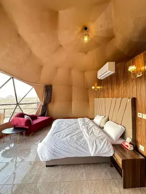 a bedroom with a large bed in a room at Wadi Rum Neom camp in Wadi Rum