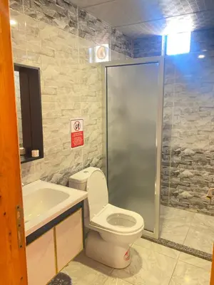 a bathroom with a shower and a toilet and a sink at Ram Al-Umda Luxury Camp in Wadi Rum