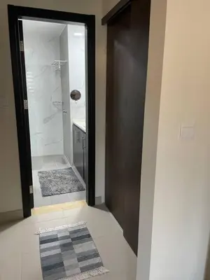 a bathroom with a walk in shower and a glass door at The F52 Luxury Residence Samarah Resort in Sowayma