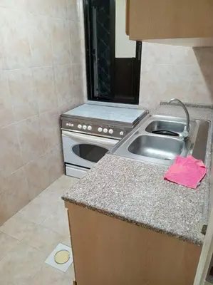 a kitchen with a sink and a stove at Kamalia Studio in Şāfūţ