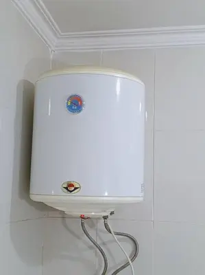a white appliance on a wall in a room at Kamalia Studio in Şāfūţ