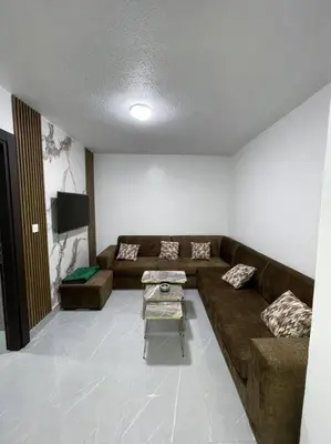 a living room with a couch and a table at شقارى 12 in Ţāb Kirā‘