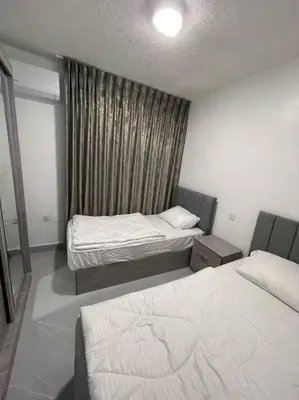 a small room with two beds and a window at شقارى 11 in Ţāb Kirā‘