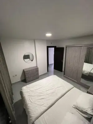 a bedroom with a large bed in a room at شقارى 11 in Ţāb Kirā‘