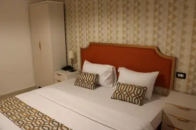 a bedroom with a bed with two pillows on it at New Rafi Hotel in Amman