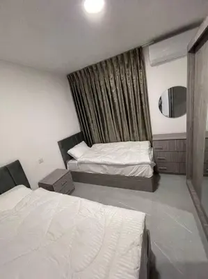 a hotel room with two beds and a window at شقارى 14 in Ţāb Kirā‘