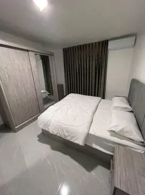 a bedroom with a large bed and a mirror at شقارى 6 in Ţāb Kirā‘