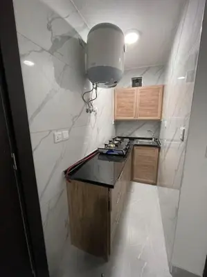 a small kitchen with a counter and a light at شقارى 6 in Ţāb Kirā‘
