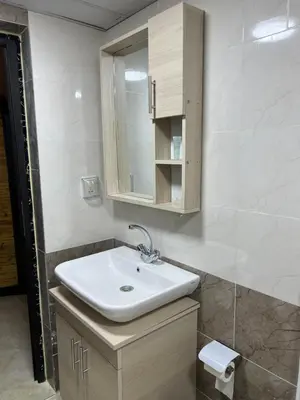a bathroom with a white sink and a mirror at Royal Dunes Camp in Wadi Rum