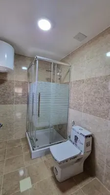 a bathroom with a shower and a toilet in it at City centre Apartment in Petra