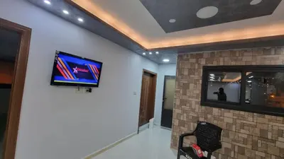 a living room with a tv on a wall at City centre Apartment in Petra