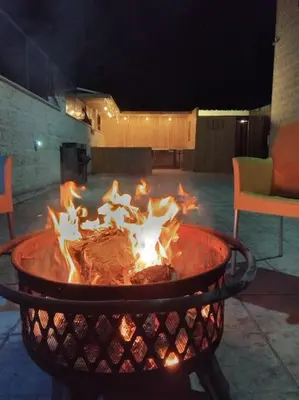 a large fire pit with flames in it at Vienna Villa for you in Al Qasţal