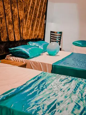 a group of three beds in a room at Rum Ronaldo camp in Wadi Rum