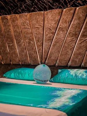 a swimming pool with two green pillows next to it at Rum Ronaldo camp in Wadi Rum
