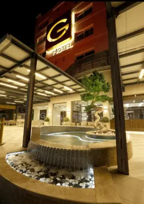a building with a water fountain in front of a building at G Hotel Amman in Amman