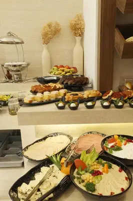 a table with many plates of food on it at G Hotel Amman in Amman