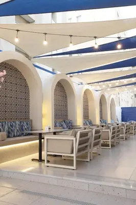 a row of white tables and chairs in a building at G Hotel Amman in Amman
