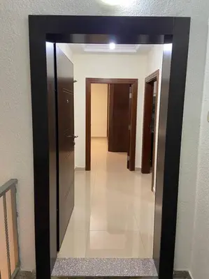 a hallway with a large mirror in a building at Apartment in Amman Khalda in Amman