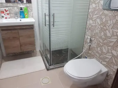 a bathroom with a shower and a toilet and a sink at Apartment in Amman Abdoun area in Amman