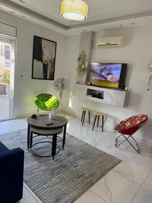 a living room with a table and two chairs at Modern Rooftop apartment in Amman