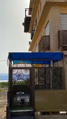 a blue cover on a balcony of a building at SeaStar Sea View apartment 10 minutes away from beach in Sowayma
