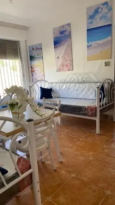 a living room with a bed and a table and chairs at SeaStar Sea View apartment 10 minutes away from beach in Sowayma