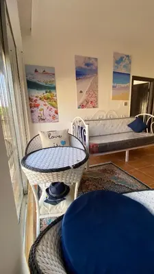 a living room with two tables and a bed at SeaStar Sea View apartment 10 minutes away from beach in Sowayma