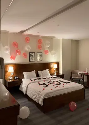 a bedroom with a bed with balloons on the wall at North paradise hotel in Irbid