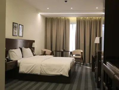 a hotel room with a bed and a table and chairs at North paradise hotel in Irbid