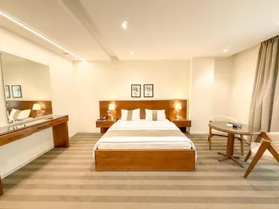 a hotel room with a large bed and a desk at North paradise hotel in Irbid