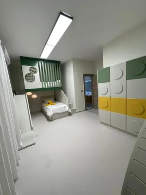 a bedroom with a bed and a skylight at Nozoll Boutique Residences in Amman