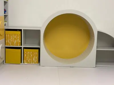 a room with a large circular room with yellow cabinets at Nozoll Boutique Residences in Amman