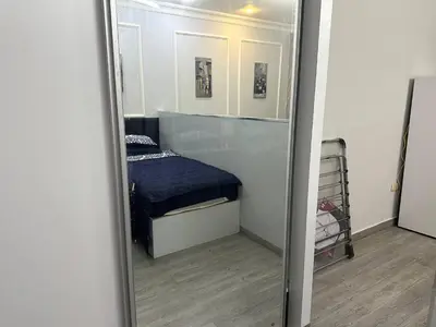 a mirror reflection of a bedroom with a bed in it at استوديو مفروش لشخصين الجاردنز 320 in Amman