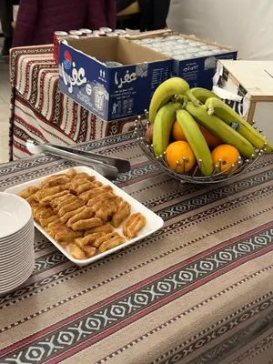 a table with two bowls of bread and bananas and oranges at Rum thabit camp in Wadi Rum