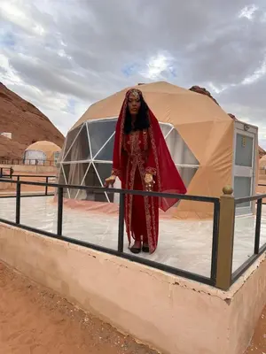 a woman standing in front of a tent at Rum thabit camp in Wadi Rum