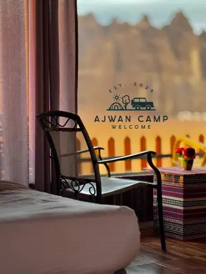 a room with a table and a chair and a window at WADI RUM AJWAN lUXURY CAMP in Wadi Rum