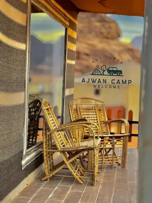 a group of chairs and tables on a patio at WADI RUM AJWAN lUXURY CAMP in Wadi Rum